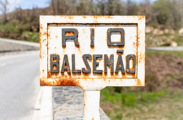 Rio Balsemão (Balsemão river) sign at Ponte de Reconcos bridge, Bigorne, Magueija e Pretarouca, Lamego, district of Viseu, Portugal - obrazy, fototapety, plakaty