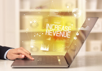 Side view of a business person working on laptop