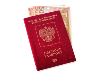 A red Russian passport for travelling and going abroad with a bunch of euros banknotes inside, isolated.