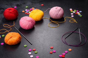 Colorful balls of wool on concrete table. Variety of yarn balls