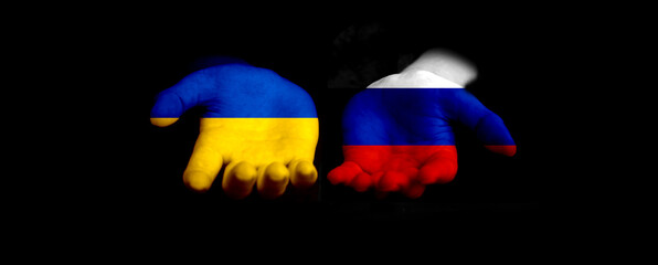 Russian and Ukraine flags concept. Peace, stop the war. Hands with flags