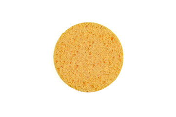 Round yellow sponge for the face, isolated on white.