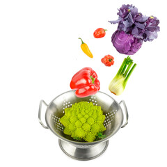 Vegetables fall into a colander isolated on a white background. Collage.