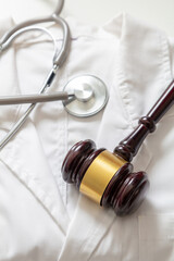Health and Law. Medical malpractice, personal injury lawyer. Judge gavel and doctor stethoscope