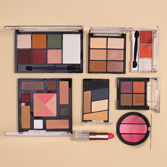 Creative layout arrangement with make up fashion products on pastel beige background. Flat lay