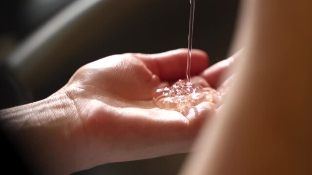 shampoo is poured into the hand. clear liquid