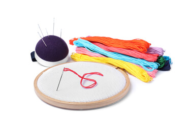 Colorful threads and different embroidery accessories on white background