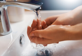 Keeping hands clean. Closeup shot of a hands being washed at a tap.