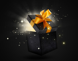 Beautiful gift box with magic light on dark background