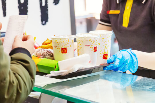 Moscow, Russia - March, 2022: Worker Giving A Tray With Food In McDonald's Restaurant. Sanctions In Russia Concept.