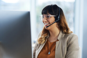 Its an absolute pleasure helping you. Cropped shot of an attractive young businesswoman sitting and...