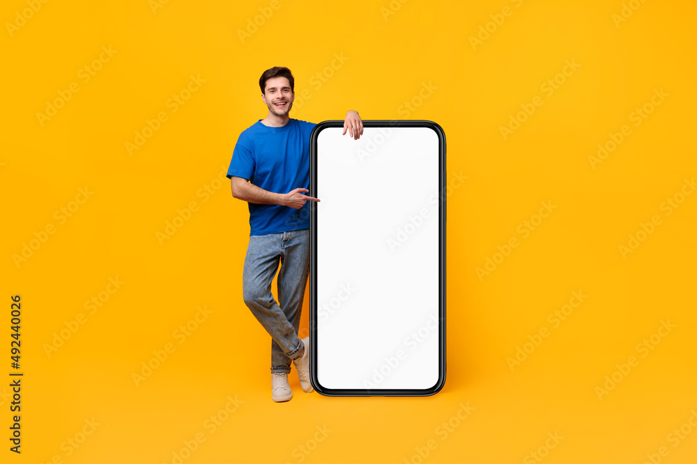 Poster guy pointing and leaning on big white empty smartphone screen