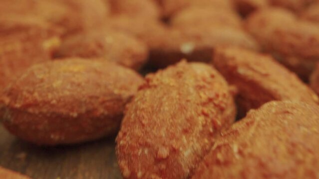 Nuts in sauce close-up. delicious fried kibbe on wooden table, top view. nuts background above closeup