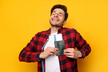 Excited guy holding showing tickets and passport