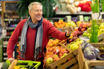 Cheerful elderly man enjoying high quality products at supermarket