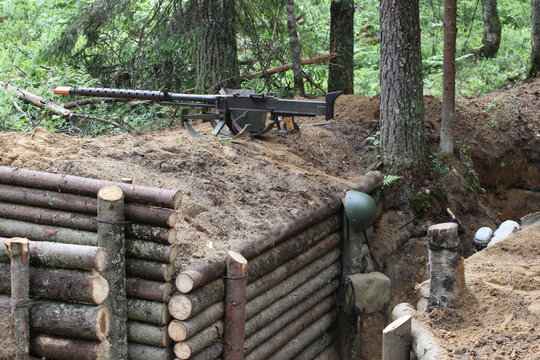 The position of the machine gunner in a wooden trench in the forest. A large anti-tank machine gun of the Finnish army during World War II. Fighting on the Karelian Isthmus.