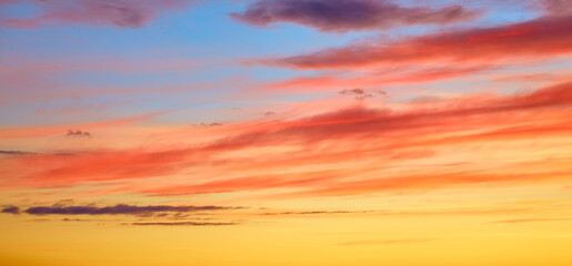Bright colored sunset sky with colorful clouds. Abstract natural landscape. Sunny sunrise. Yellow,...