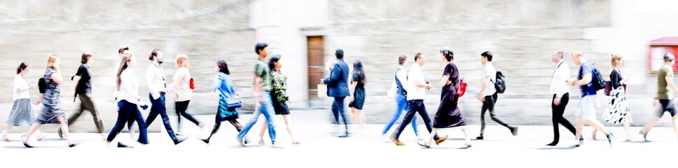 People walking in the City, blurred wide background representing modern fast moving life in the capital City. People crossing the road. 