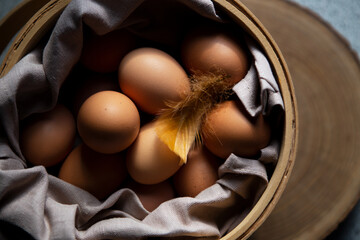 Raw organic brown chicken eggs in basket