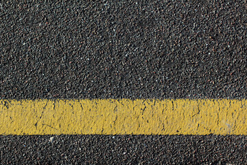 asphalt background with yellow lines