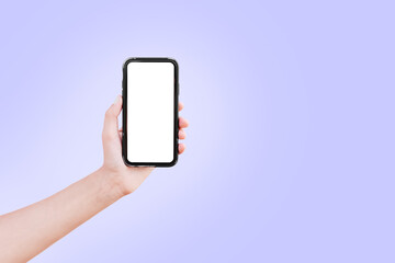 Hand holding smartphone with mockup. Background of very peri color. Close-up.