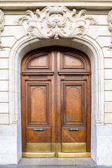 Paris, an ancient wooden door, beautiful facade in the 11e arrondissement
