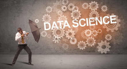 Obraz premium Businessman defending with umbrella concept