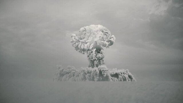 massive black and white nuke bomb test explosion with film look and a large shockwave hitting camera