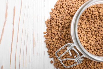 buckwheat tea in a jar on a white wooden background