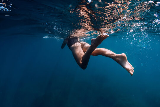 Sporty woman in bikini swimming in blue ocean. Activity summer days in sea