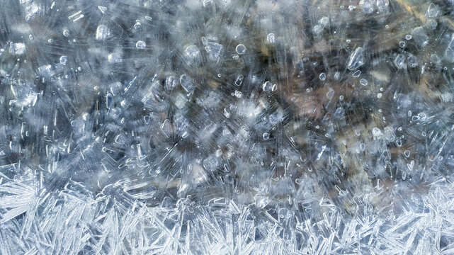Winter texture ice background with for banner closeup. Ice crystals and air bubbles on a frozen river. Texture of ice crystals.