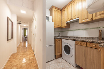 Short-term apartment distributor with oak furniture kitchen and pink granite countertop and long corridor with oak parquet floors