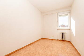 empty room with orange stoneware floor, white aluminum window and white painted walls