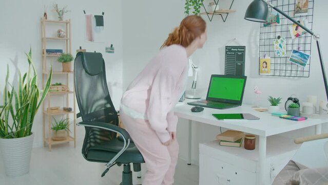 Female designer using laptop at home