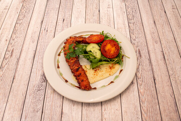 Grilled octopus leg with Greek salad