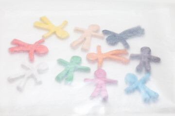 multicolored clay figurines covered with transparent paper