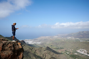 A young man admiring the beautiful views in the mountains in Gran Canaria