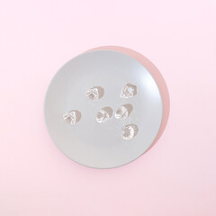 Diamonds in a plate on a pink background. Surreal aesthetic food concept.