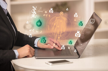 Doctor working on laptop with healthcare concept
