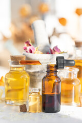 Assortment of organic essential oils. Natural moisturizing body and face treatment. Rose, camomile extract for healthy young skin. Relaxation, aromatherapy, salon spa. Close up, macro view