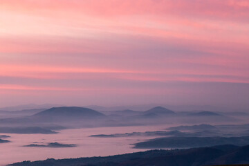 Fototapeta na wymiar Mist and fog between valley and layers of mountains and hills at sunset, in Umbria Italy