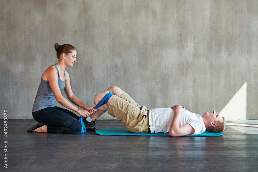 Canvas Prints She pushes him further. Shot of a female physiotherapist having a session with a young male amputee.