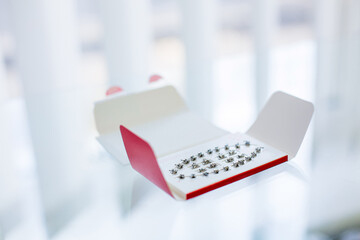 Dentist braces lying on a shiny glass table in a professional stomatologic doctor's cabinet