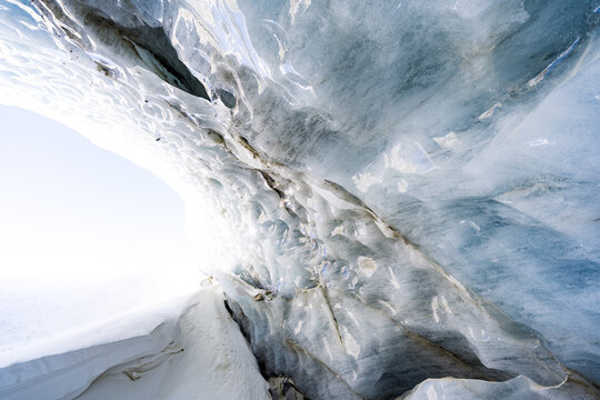 Breaking ice in glacier, ice wall texture taken from a natural glacier cave in Zinal, Switzerland 