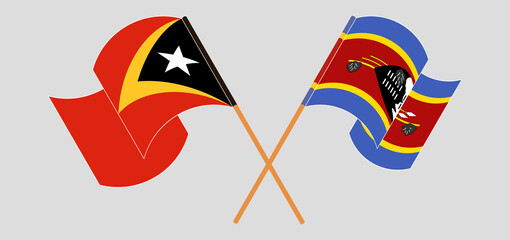 Crossed and waving flags of East Timor and Eswatini