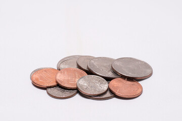 Closeup of a stack of coins on white background with copy space