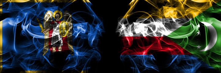 Kyiv, Kiev vs Comoros, Comorian flag. Smoke flags placed side by side isolated on black background.