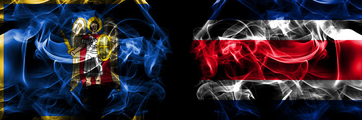 Kyiv, Kiev vs Costa Rica flag. Smoke flags placed side by side isolated on black background.