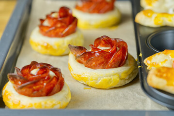 fresh homemade pastries. puff pastry appetizers mix. rose-shaped pepperoni cake. pastry with salami. close up