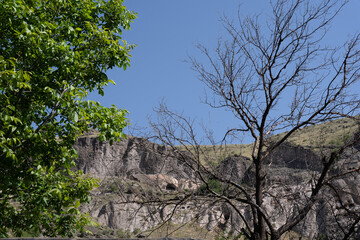 a beautiful fabulous mountain trail with a fence along the edge, where in the distance you can see the clan village.